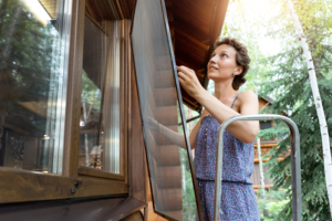 Homeowners installing window screens, DIY window screen installation